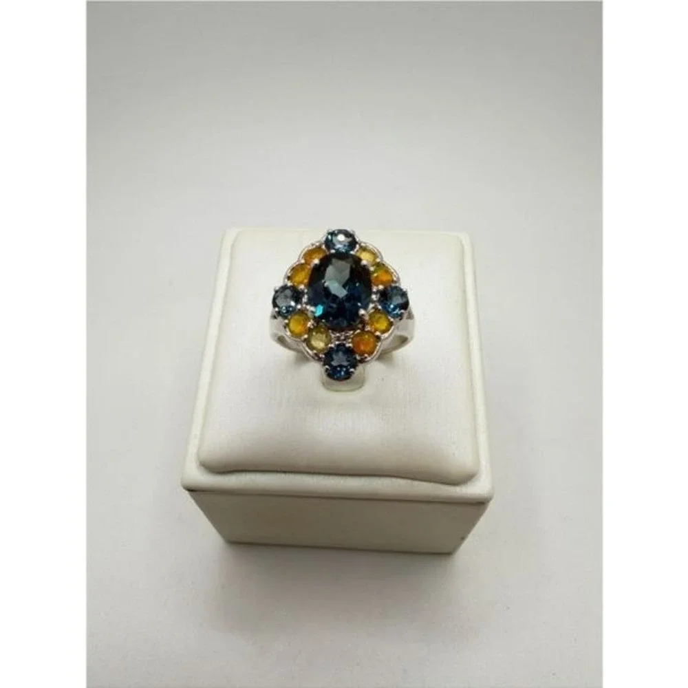 Stunning oval cut, faceted London Blue topaz and opal accent, 925 ring!